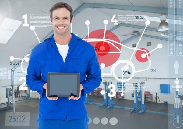Smiling mechanic holding a tablet with digital car diagnostics overlay.