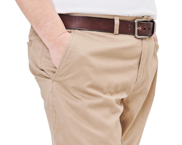 A person wearing beige chinos with a brown leather belt and silver buckle.